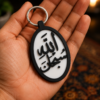 Subhanallah Islamic Arabic calligraphy keychain by TREEDKW held in hand